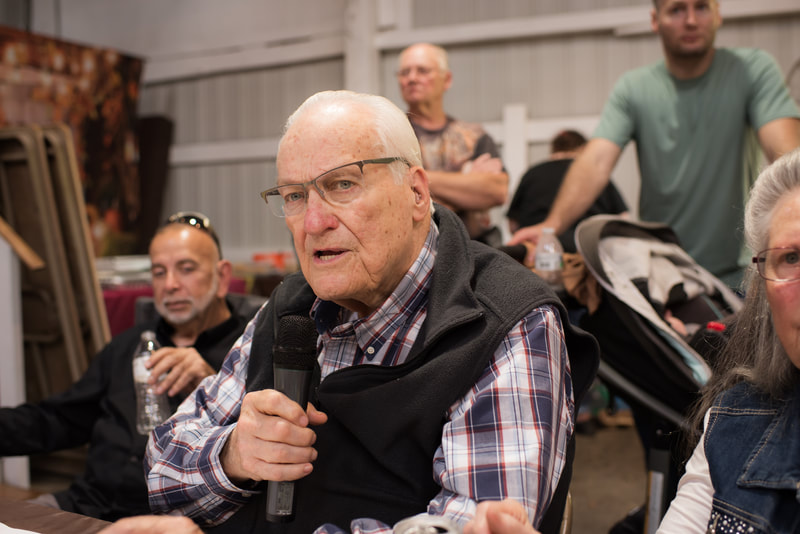A man speaking into a microphone during a church gathering